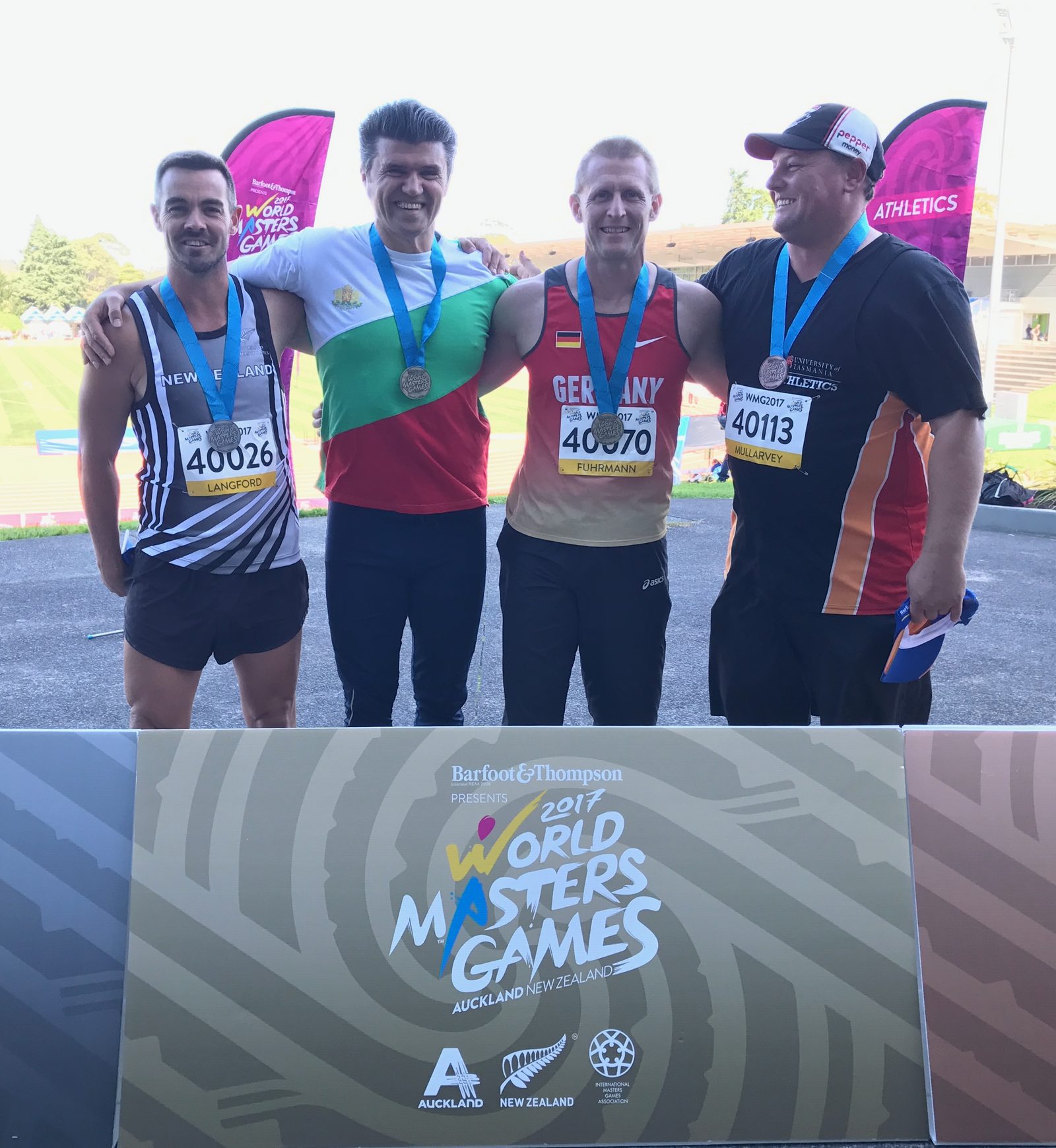 Peter Ivanov on the podium at the 2017 World Masters Games discus throw event